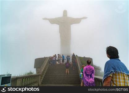 RIO DE JANEIRO, BRAZIL - MARCH 2, 1916 : View of tourists in front of the Christ the Redeemer statue in the mist at Rio de Janeiro, Brazil