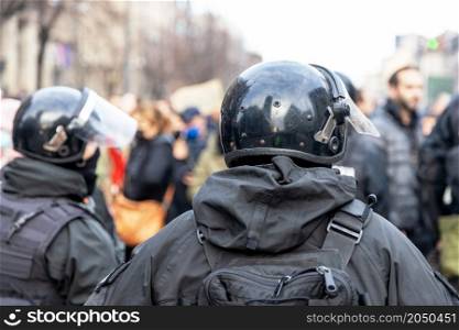 Riot police on duty during crowd protest or demonstration