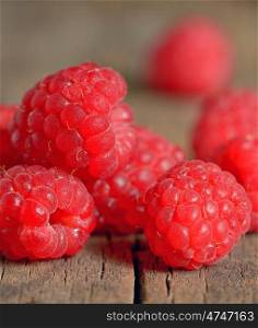 Ripe and fresh raspberry on wooden table
