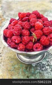 Ripe and juicy raspberries. Full ramekin of berries ripe raspberry on metal background