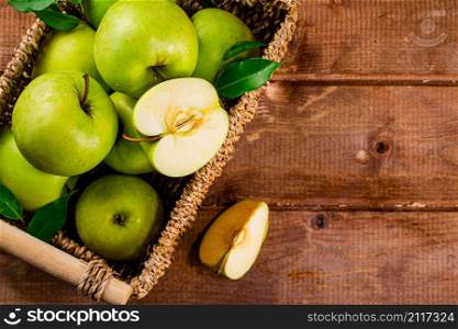 Ripe apples in a basket on the table. On a wooden background. High quality photo. Ripe apples in a basket on the table.