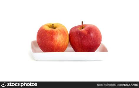 ripe apples on the white plate on white background