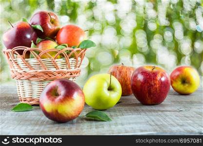 Ripe apples on the wooden table in the garden. Fresh fruits. Fresh apples. Vegetarian food. Healthy eating concept. Healthy food. Healthy eating. . Ripe fresh apples on the wooden table in the garden