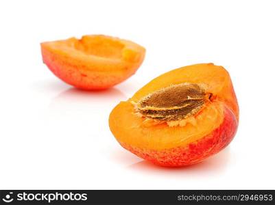 Ripe apricot with a stone on a white background