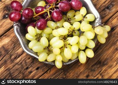 Ripe autumn grapes. Ripe large grapes on a stylish dish