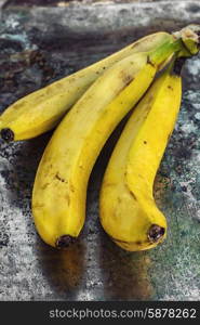 Ripe bananas. Ligament large ripe and fragrant bananas on wooden background.