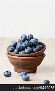Ripe blueberries in a bowl on the table, healthy and tasty berry