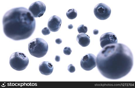 Ripe blueberries levitate on a white background.. Ripe blueberries levitate on a white background