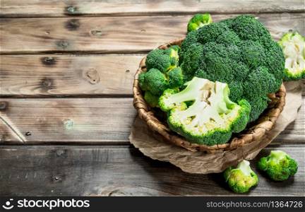 Ripe broccoli in the basket. On a wooden background.. Ripe broccoli in the basket.