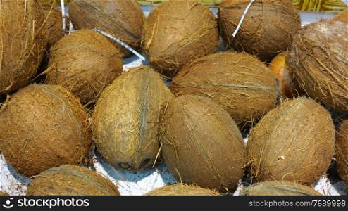 Ripe coconuts in supermarket for sale as background