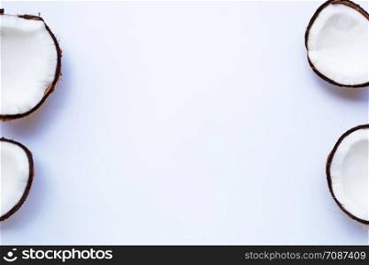 Ripe coconuts on white background. Top view of tropical fruit. Copy space