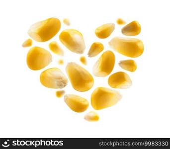 Ripe corn grains in the shape of a heart on a white background.. Ripe corn grains in the shape of a heart on a white background