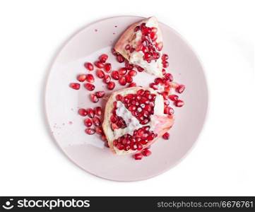 ripe cuting pomegranate at plate around white background