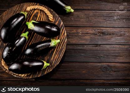 Ripe eggplant on a wooden tray. On a wooden background. High quality photo. Ripe eggplant on a wooden tray. 