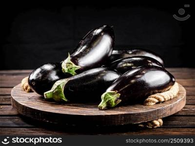 Ripe eggplant on a wooden tray. On a wooden background. High quality photo. Ripe eggplant on a wooden tray. 