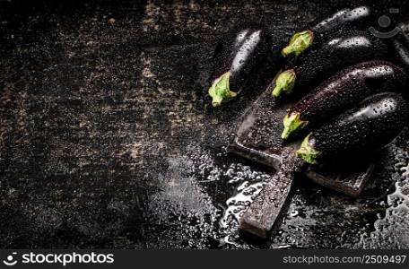 Ripe eggplant with droplets of water. On a black background. High quality photo. Ripe eggplant with droplets of water. 