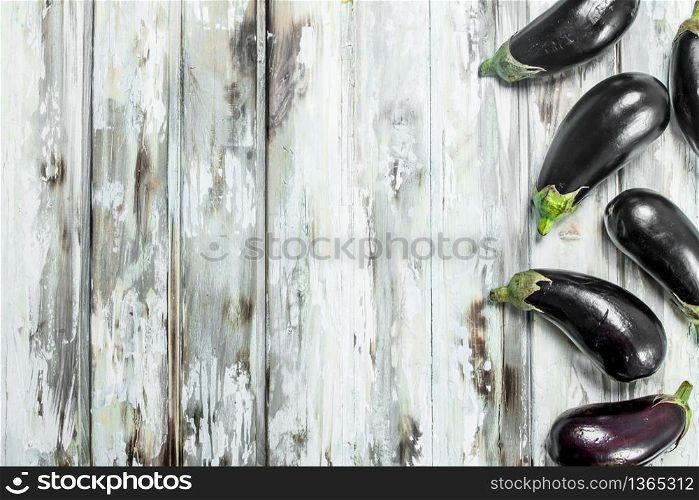 Ripe eggplants are shiny. On wooden background. Ripe eggplants are shiny.