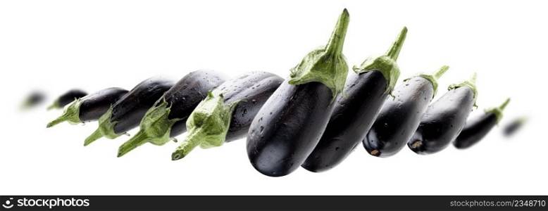 Ripe eggplants levitate on a white background.. Ripe eggplants levitate on a white background