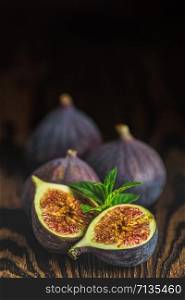 Ripe Fig Fruits on old wooden background. Paleo diet, still life with copy space. Shallow depth of the field.