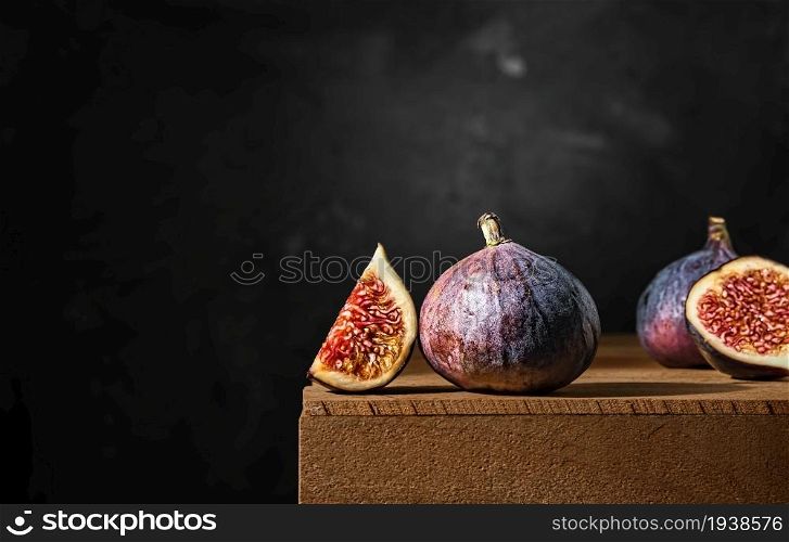Ripe figs on a wooden box. Close-up, selective focus