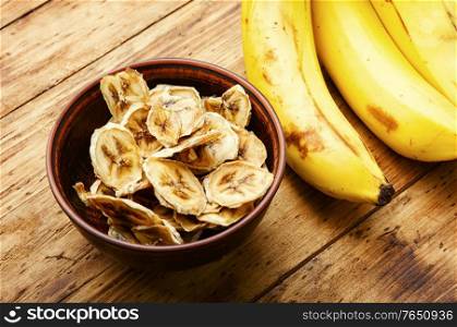 Ripe fresh and dried banana.Dried sweet on wooden background. Delicious dried bananas