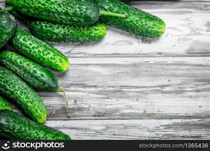 Ripe fresh cucumbers. On wooden background. Ripe fresh cucumbers.