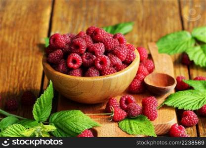 Ripe fresh raspberry in wooden bowl on table. Ripe fresh raspberry in wooden bowl.