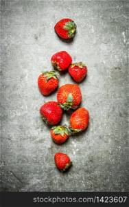Ripe fresh strawberry. On the stone table.. Ripe fresh strawberry.