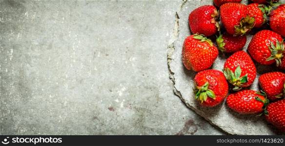 Ripe fresh strawberry. On the stone table.. Ripe fresh strawberry.