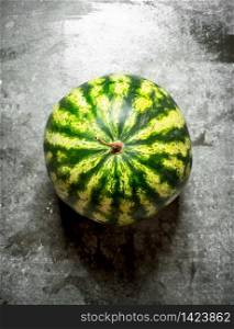 ripe fresh watermelon. On the stone table.. ripe fresh watermelon.