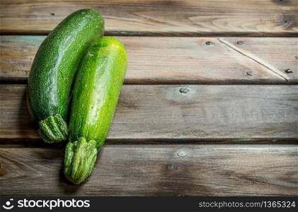 Ripe fresh zucchini. On wooden background. Ripe fresh zucchini.