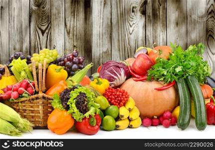 Ripe fruits and vegetables on dark wooden background for kitchen panel. Copy space