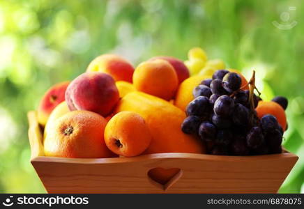 ripe fruits on wooden basket