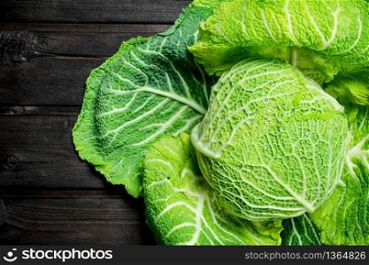 Ripe green cabbage. On a wooden background.. Ripe green cabbage.