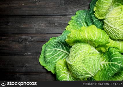Ripe green cabbage. On a wooden background.. Ripe green cabbage.