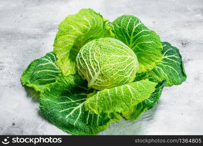 Ripe green cabbage . On rustic background. Ripe green cabbage .