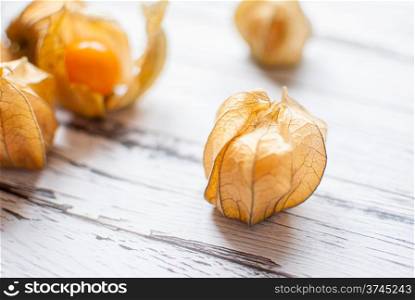 ripe healthy orange physalis over wooden board