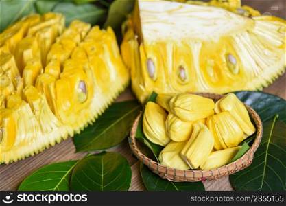 Ripe jackfruit peeled tropical fruit fresh from jackfruit tree, jackfruit on basket with leaf on wooden background