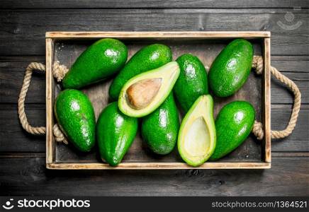 Ripe juicy avocado on the old dressing. On a wooden background.. Ripe juicy avocado on the old dressing.