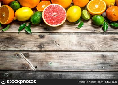 Ripe juicy citrus with leaves. On wooden background. Ripe juicy citrus with leaves.