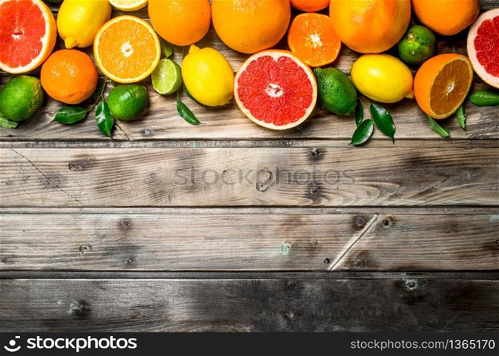 Ripe juicy citrus with leaves. On wooden background. Ripe juicy citrus with leaves.