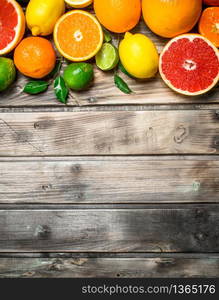 Ripe juicy citrus with leaves. On wooden background. Ripe juicy citrus with leaves.