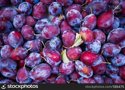 Ripe juicy plums as background
