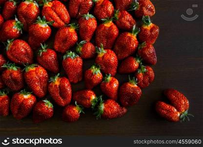 ripe juicy strawberries on a wooden table