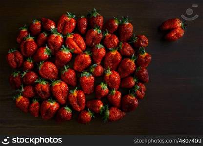 ripe juicy strawberries on a wooden table
