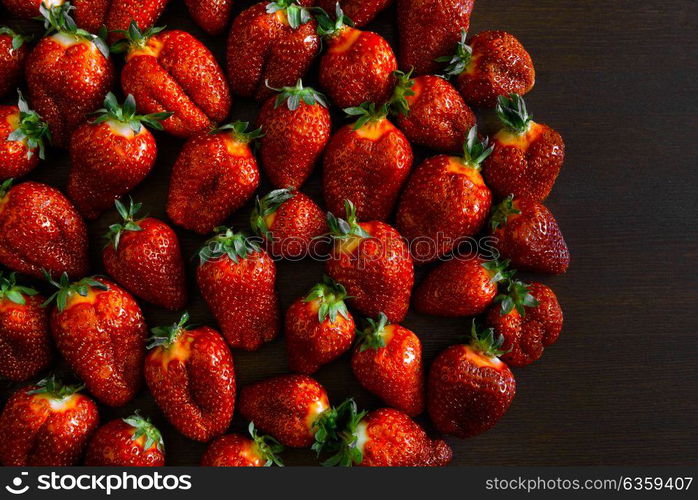 ripe juicy strawberries on a wooden table