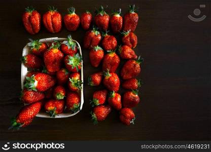 ripe juicy strawberries on a wooden table in a basket