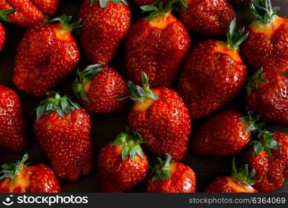 ripe juicy strawberries on a wooden table in a basket