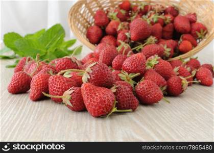 Ripe, juicy strawberries sprinkled on the table close-up