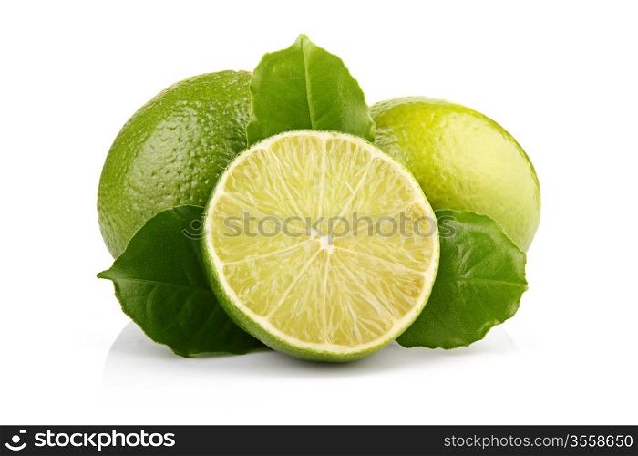 Ripe lime fruits with green leaves isolated on white background